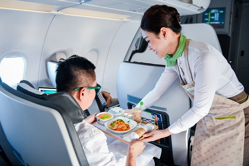 Tiếp viên phục vụ suất ăn nóng cho khách hàng - Dịch vụ trên máy bay của Bamboo Arways